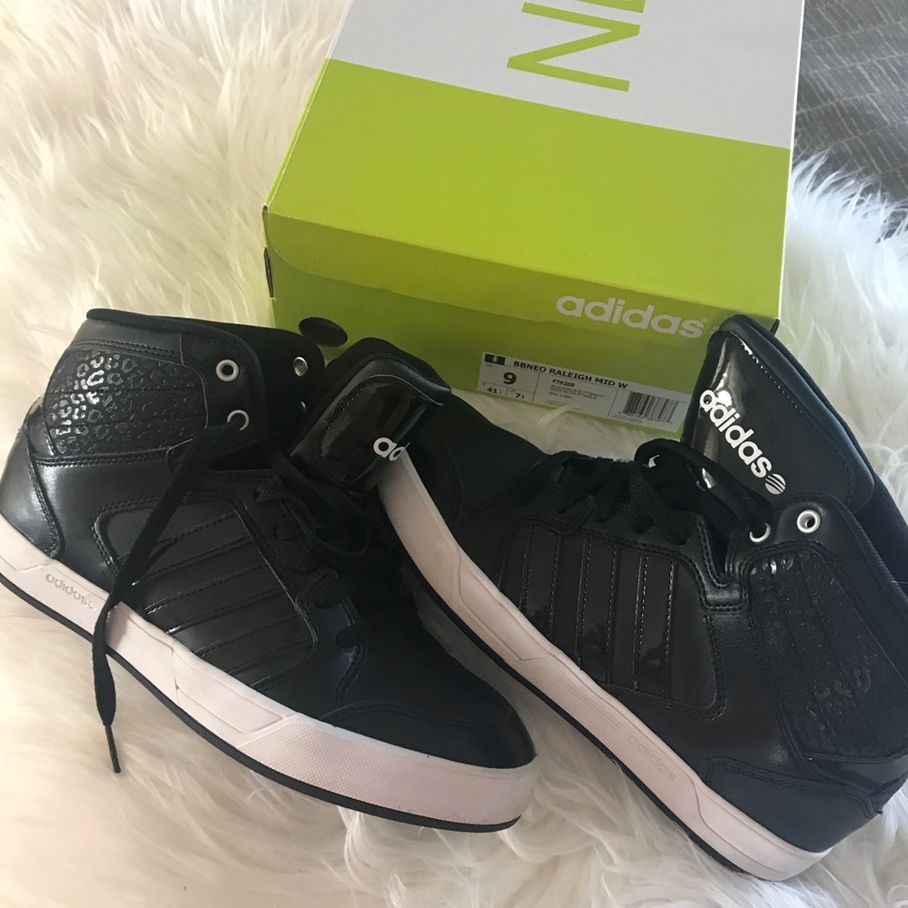 Women’s black Adidas mid lace up sneaker.